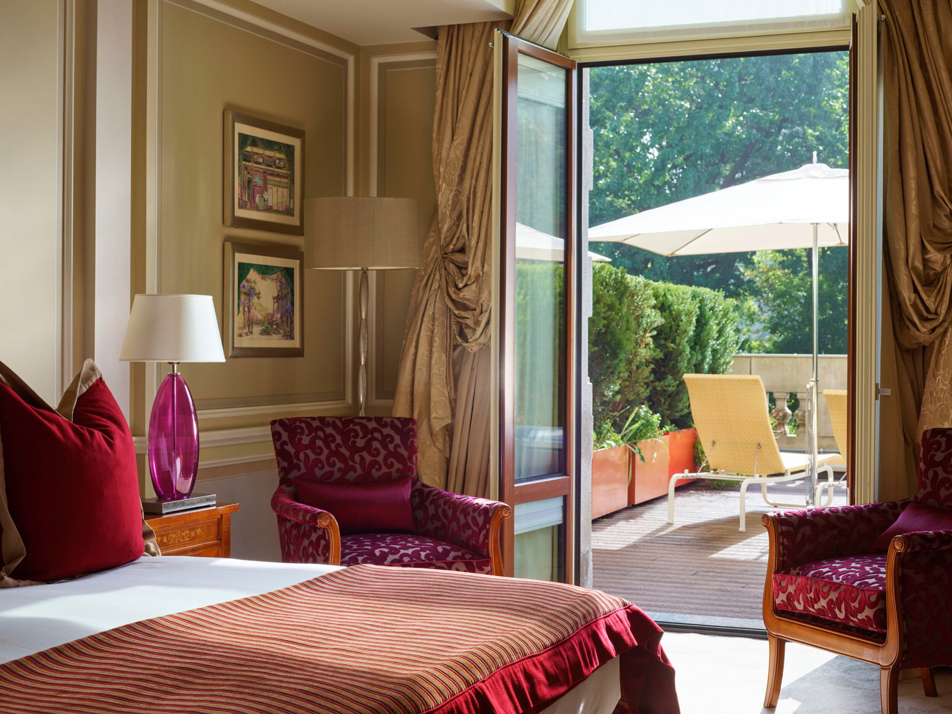 Bedroom with terrace doors open on a sunny day at Hotel Principe Di Savoia, Milan