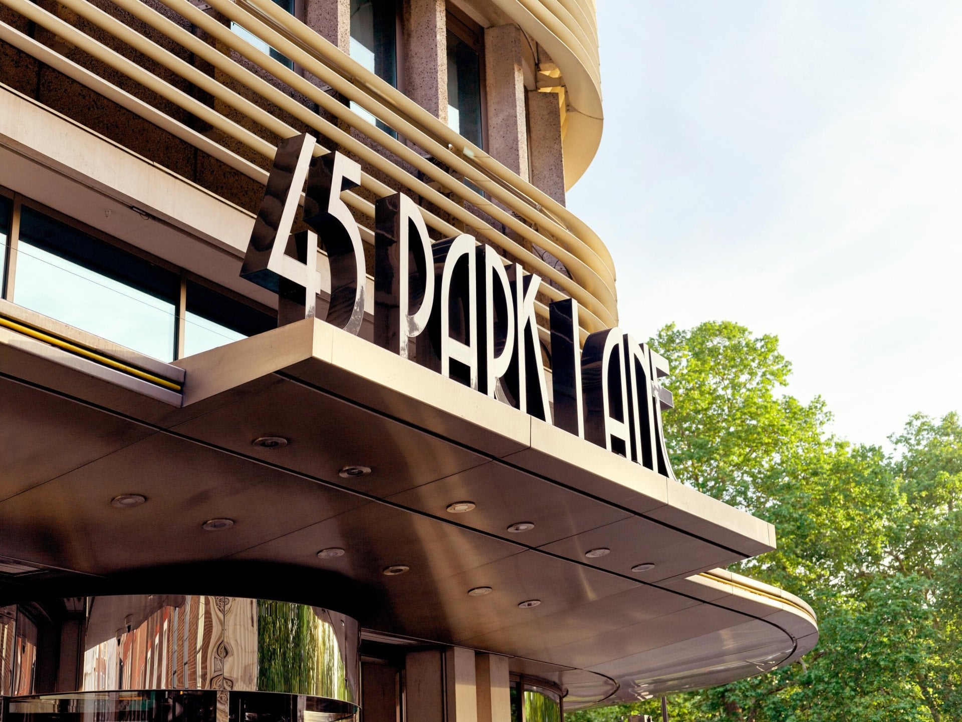 The exterior entrance of 45 Park Lane, London in daytime