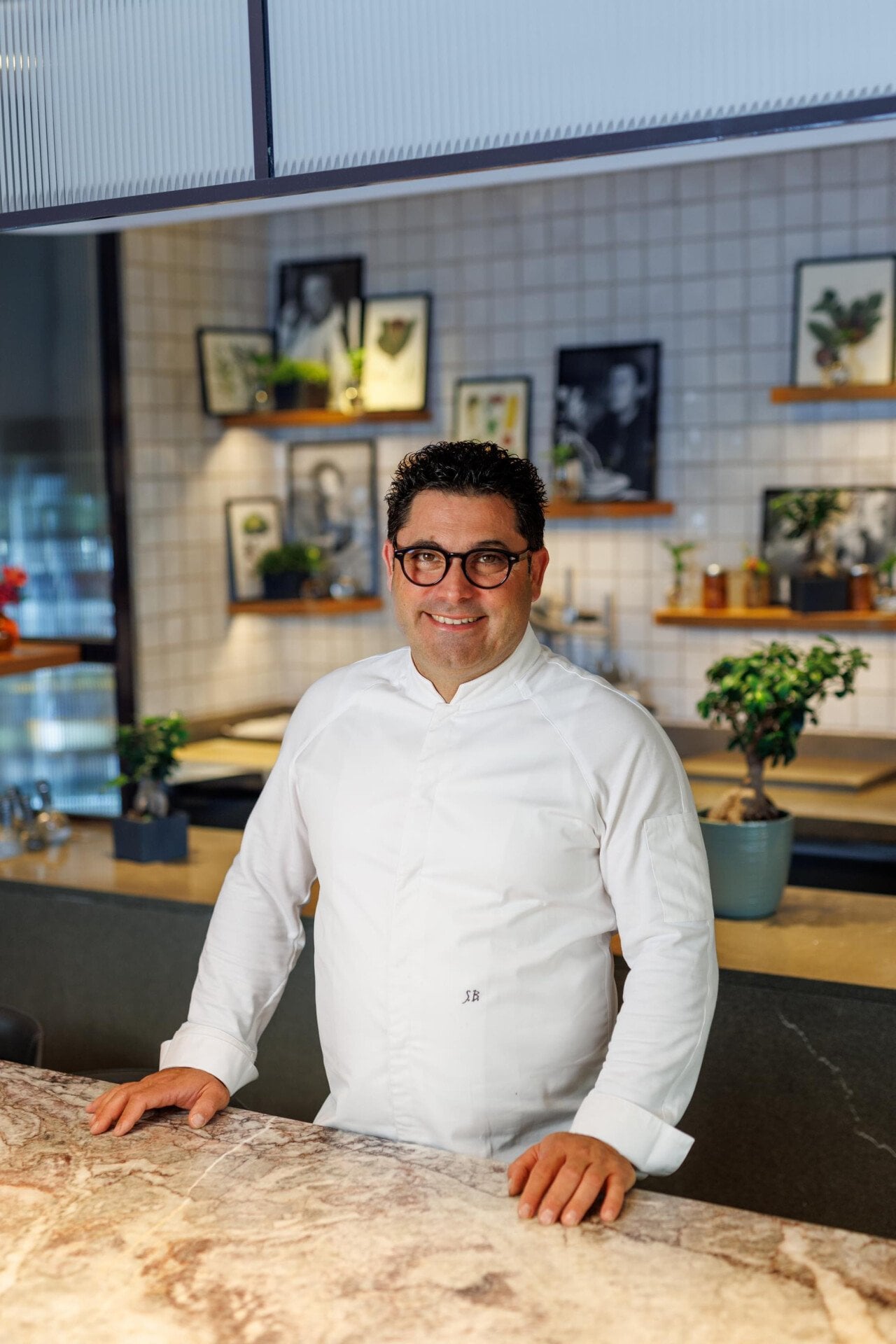Portrait of executive chef Salvatore Bianco standing at the sharing table at Il Giaridno Ristorante
