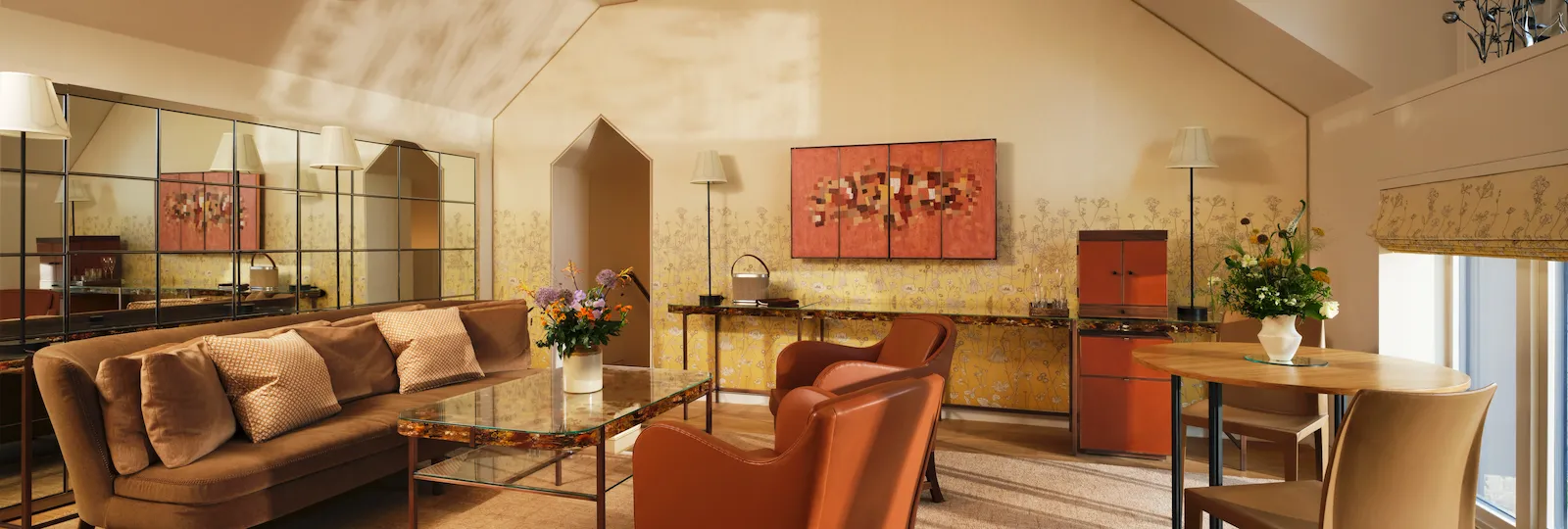 Living area in the Fairway suite with vaulted ceiling and statement chandelier at Coworth Park
