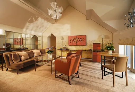 Living area in the Fairway suite with vaulted ceiling and statement chandelier at Coworth Park