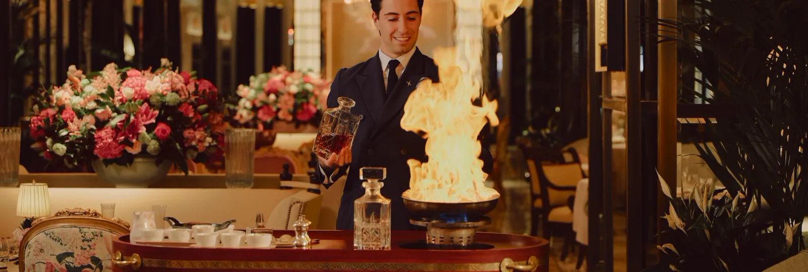 The Promenade after dark. Waiter making Steak Dianne
