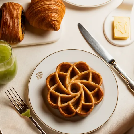 A flower-shaped waffle in a white plate