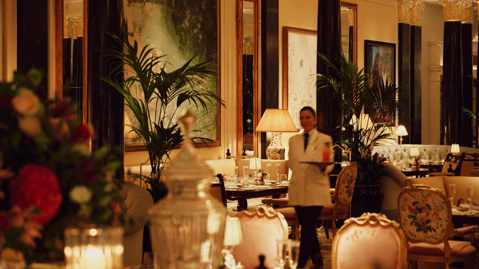 The Promenade after dark. Waitress in motion with drink on tray