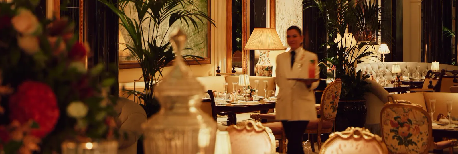 The Promenade after dark. Waitress in motion with drink on tray