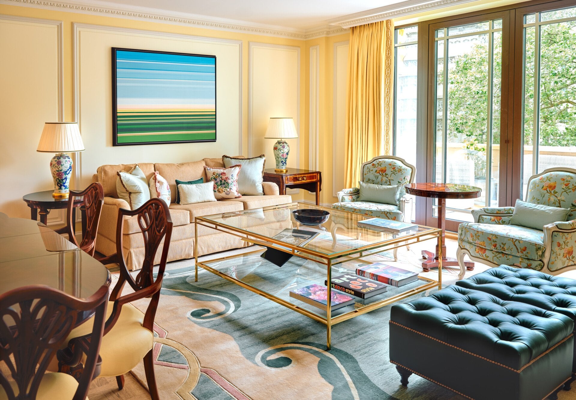 A classically elegant room in cream tones with a vibrant piece of artwork