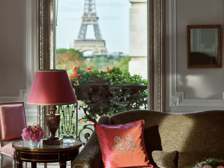 Haute Couture Suite Living room with balcony doors open to view of Eiffel Tower