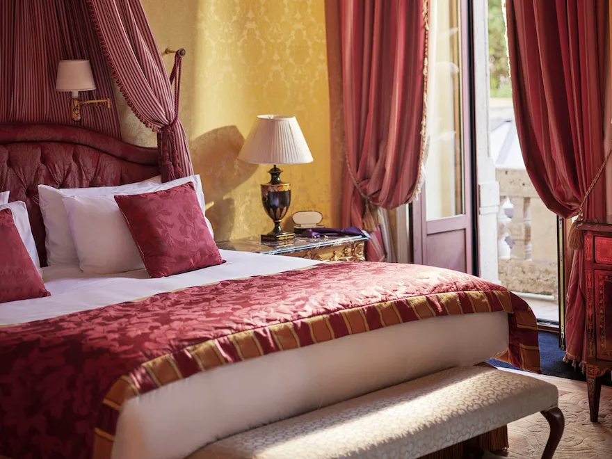 Royal Suite Bedroom Close-up showing the bed and the curtains decorated in red