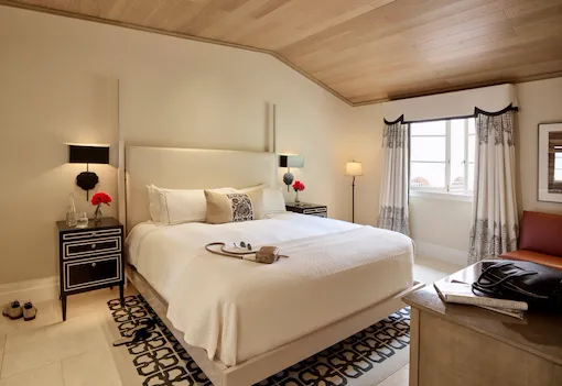 View of the second bedroom in the 2 bedroom Bel-Air Suite highlighting the spacious area, bed, and natural light that comes through the large window adjacent to the bed.