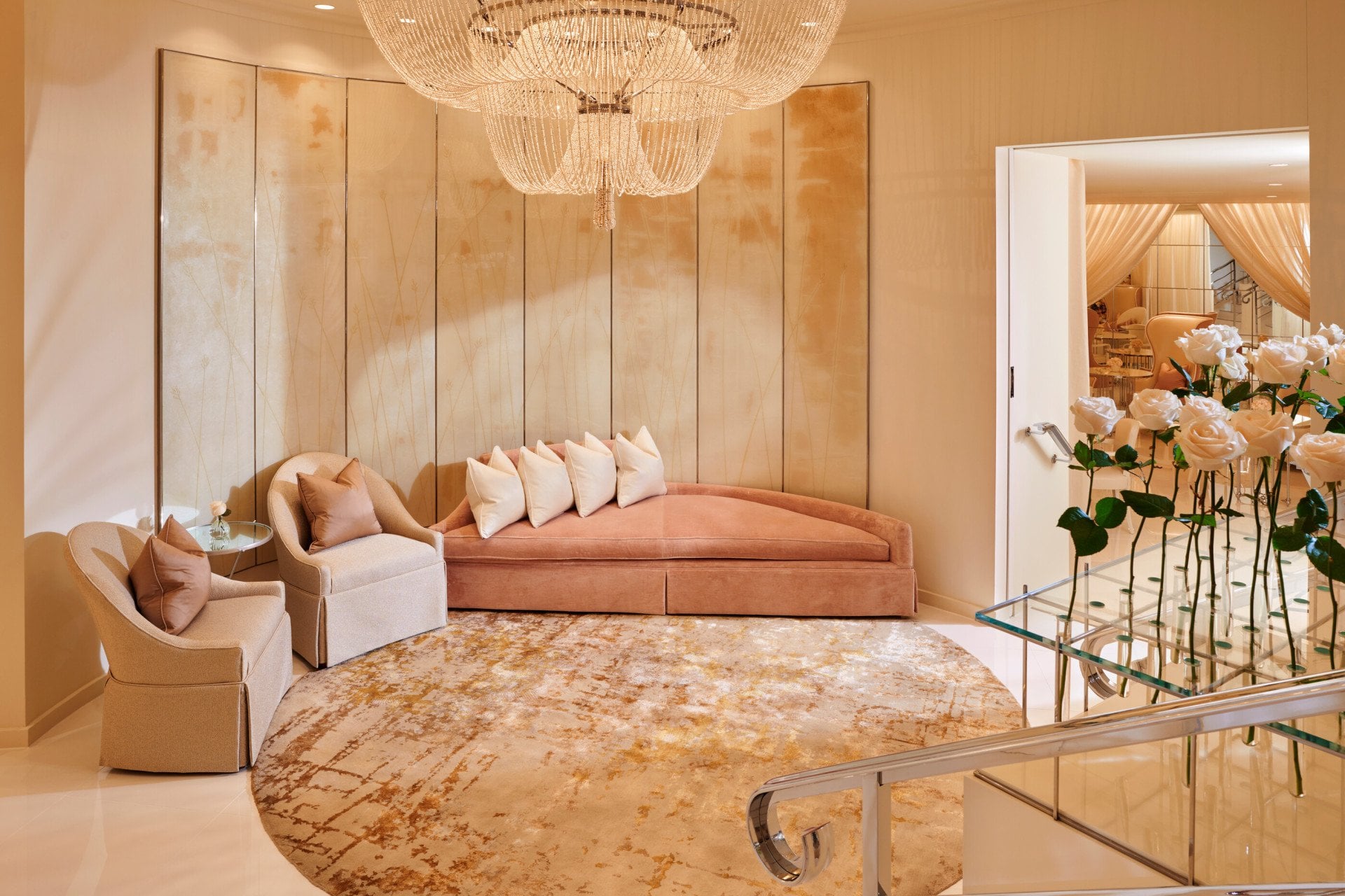 An inviting room with a chaise and a chandelier